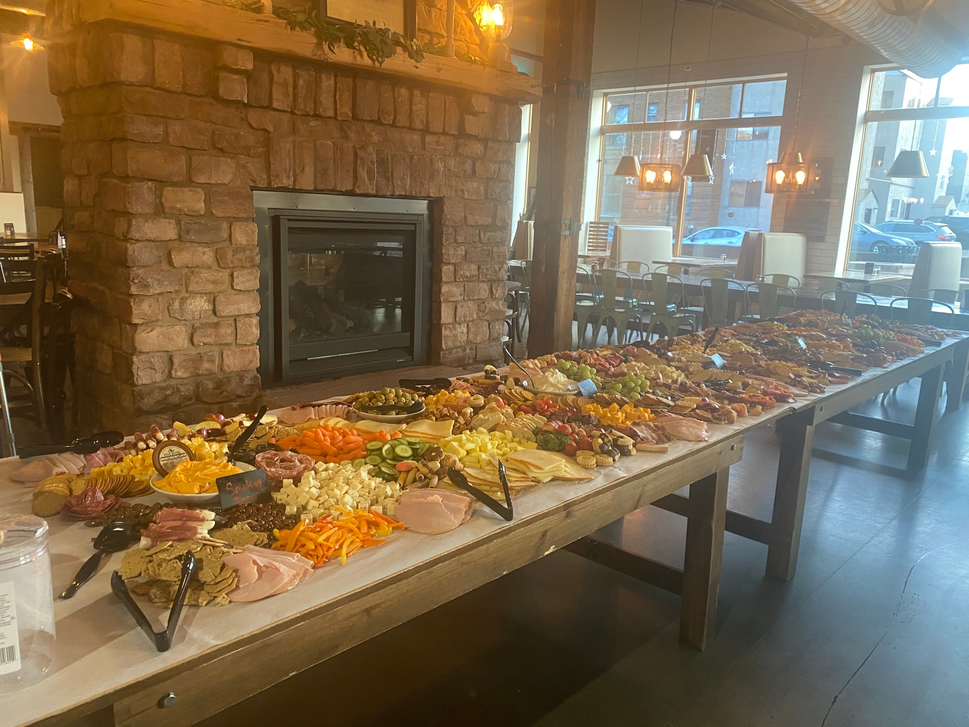 A long serving table at Josiah's with a beautiful spread of snacks and hors d'oeuvres